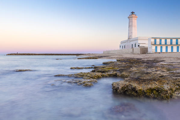 The lighthouse and beach of San Cataldo at sunset. Province of Lecce, Salento, Apulia, Italy.