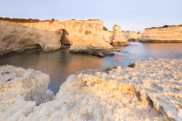 The Faraglioni of Torre Sant'Andrea at sunrise. Melendugno, province of Lecce, Salento, Apulia, Italy.