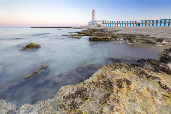 The lighthouse and beach of San Cataldo at sunset. Province of Lecce, Salento, Apulia, Italy.