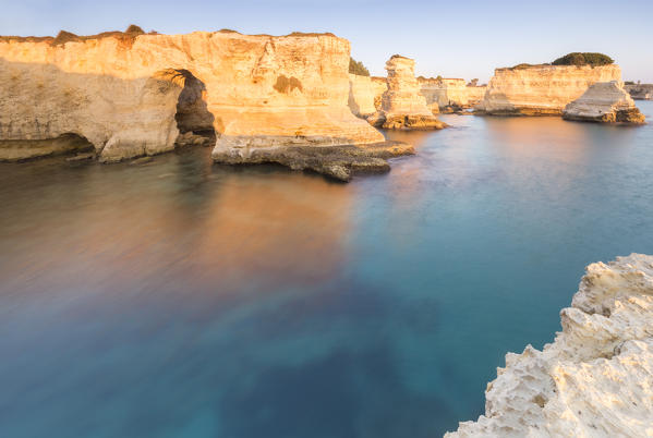 The Faraglioni of Torre Sant'Andrea at sunrise. Melendugno, province of Lecce, Salento, Apulia, Italy.