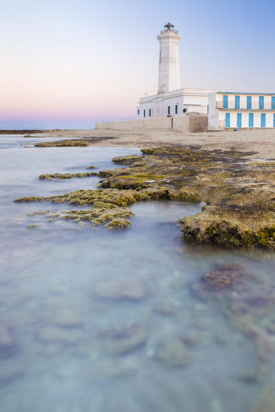 The lighthouse and beach of San Cataldo at sunset. Province of Lecce, Salento, Apulia, Italy.