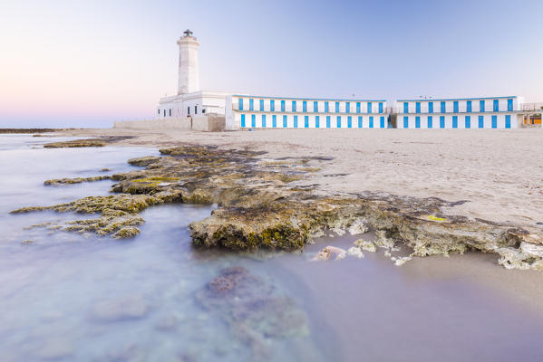 The lighthouse and beach of San Cataldo at sunset. Province of Lecce, Salento, Apulia, Italy.