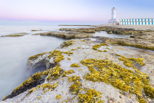 The lighthouse and beach of San Cataldo at sunset. Province of Lecce, Salento, Apulia, Italy.