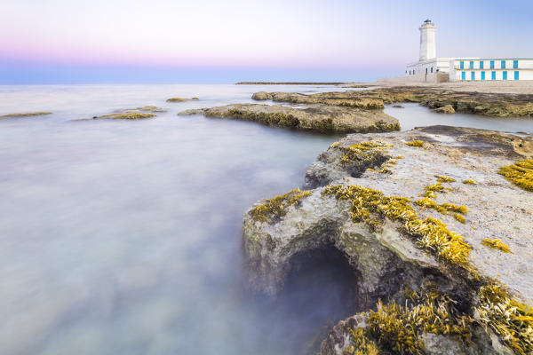 The lighthouse and beach of San Cataldo at sunset. Province of Lecce, Salento, Apulia, Italy.