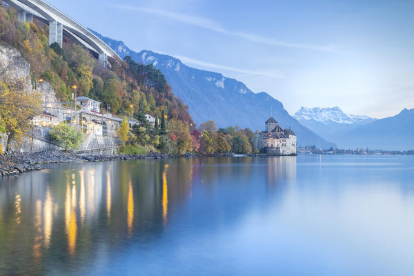 View of the Chillon castle on Lake Geneva and Dents du Midi at sunset. Veytaux, Montreux, Canton of Vaud, Switzerland.