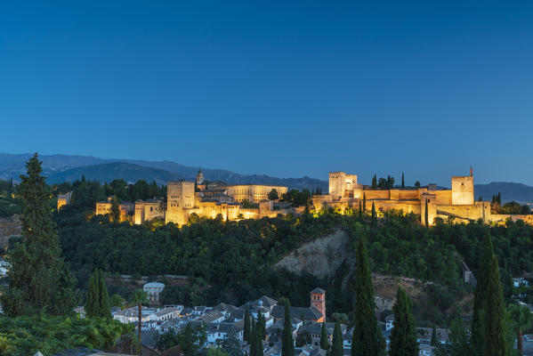 Illuminated Alhambra palace and fortress complex at dusk, Granada, Andalusia, Spain