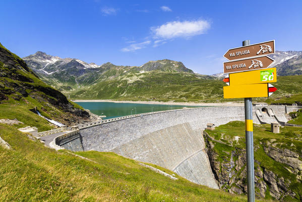 Hiking signage at dam of lake Montespluga, Chiavenna Valley, Sondrio province, Valtellina, Lombardy, Italy