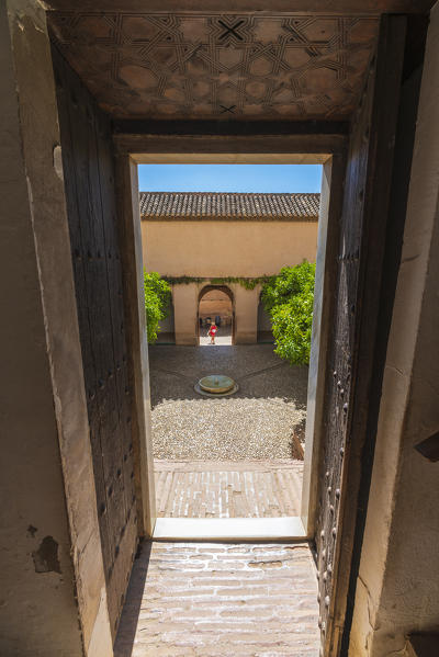 Patio of Generalife Palace (Palacio de Generalife) seen from an ancient doorway, Granada, Andalusia, Spain