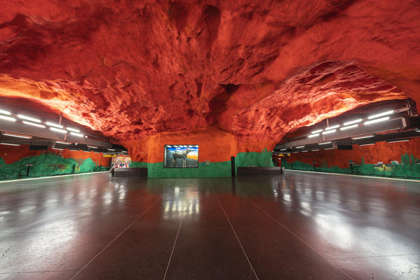 Solna Centrum metro station decorated with red and green ceiling artwork, depicts environmental and social problems, Stockholm, Sweden