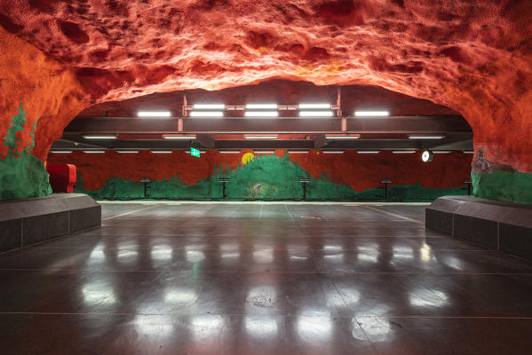 Solna Centrum metro station decorated with red and green ceiling artwork, depicts environmental and social problems, Stockholm, Sweden
