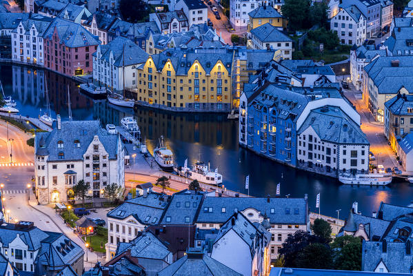 Elevated view of Art Nouveau buildings along Brosundet Canal at night, Alesund, More og Romsdal county, Norway