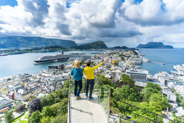 Man and woman admiring Alesund from platform at Byrampen viewpoint, Aksla, More og Romsdal county, Norway