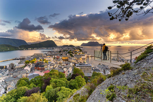 Photographer looking at Alesund during sunset from  Byrampen viewpoint, More og Romsdal county, Norway