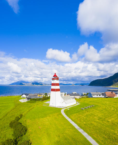 Aerial panoramic of Alnes Lighthouse in between meadows and sea, Godoya Island, Alesund, More og Romsdal County, Norway
