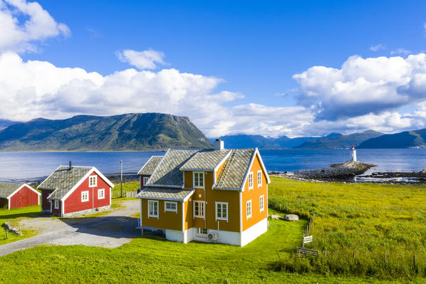 Traditional houses next to Hogsteinen Lighthouse by the sea, Godoya Island, Alesund, More og Romsdal County, Norway