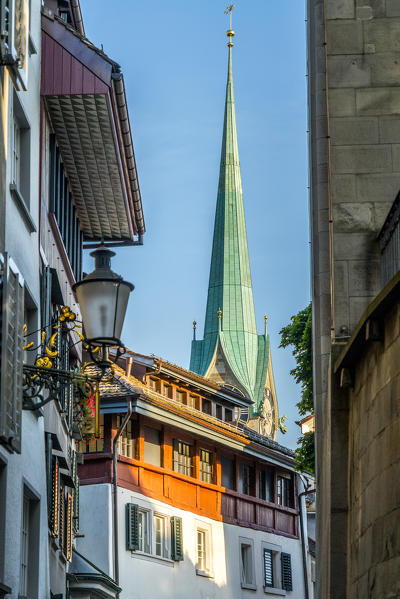 Clock tower and belfry of Fraumunster church from the old alley of Lindenhof, Zurich, Switzerland