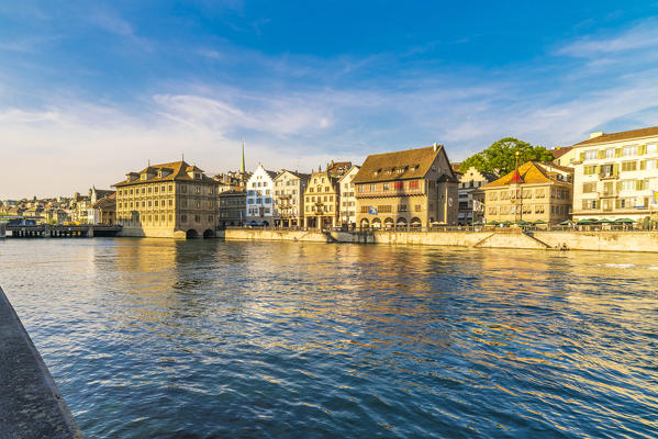 Sunset over the old buildings of Limmatquai, old street along Limmat River, Zurich, Switzerland