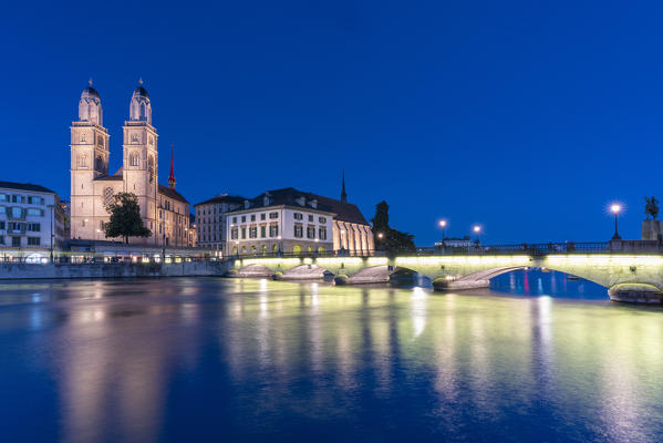 Limmatquai, Grossmunster Cathedral and Munsterbrucke bridge at dusk, Zurich, Switzerland