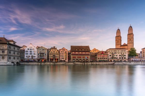 Sunset over the old buildings of Limmatquai and Grossmunster Cathedral, Zurich, Switzerland