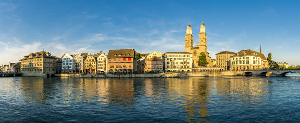 Panoramic of Limmatquai and Grossmunster Cathedral along Limmat River at sunset, Zurich, Switzerland