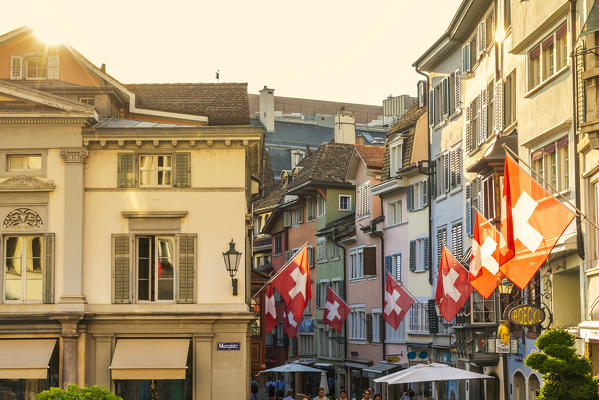 Swiss flags hanging from buildings of Lindenhof, Old Town of Zurich, Switzerland