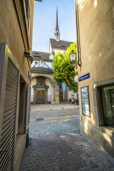 Bell tower seen from a cobblestone alley in Lindenhof, Old Town of Zurich, Switzerland