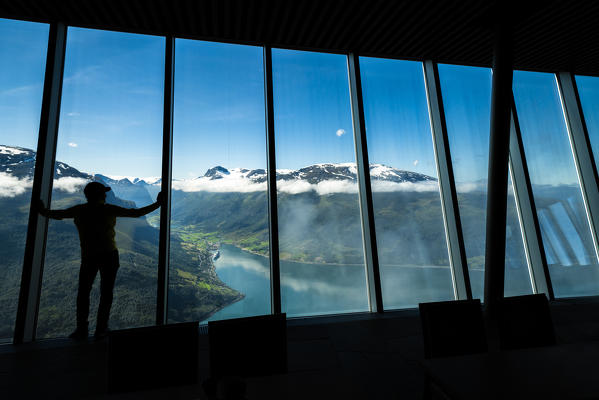 Silhouette of man looking at fjord through the glass windows inside Hoven Restaurant, Loen, Stryn, Sogn og Fjordane county, Norway