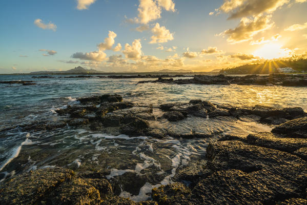 Rocks washed by the Indian Ocean lit by sunset, Trou d'Eau Douce, Flacq district, East coast, Mauritius