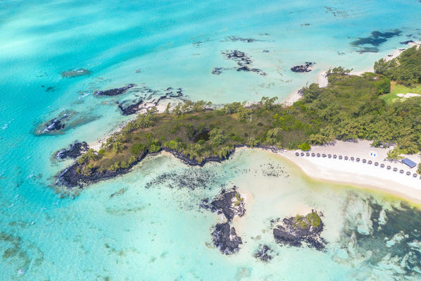 Beach umbrella and sunbed of luxury resort on white sand beach from above, Ile Aux Cerfs, Flacq district, Indian Ocean, Mauritius