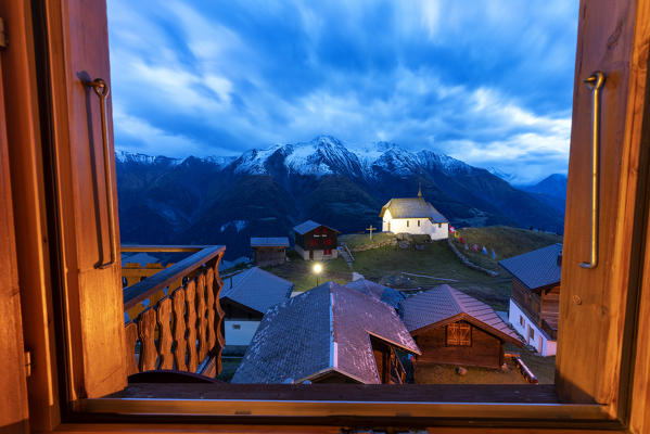 Dusk over Bettmeralp seen from the open window of chalet, canton of Valais, Switzerland
