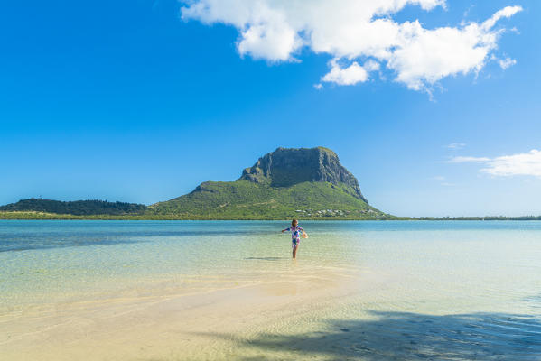 Cheerful woman sunbathing standing on sand beach in the lagoon, La Gaulette, Le Morne Brabant, Indian Ocean, Mauritius