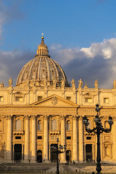Facade and dome of St. Peter's Basilica (Basilica di San Pietro) lit by sunrise, Vatican City, Rome, Lazio, Italy