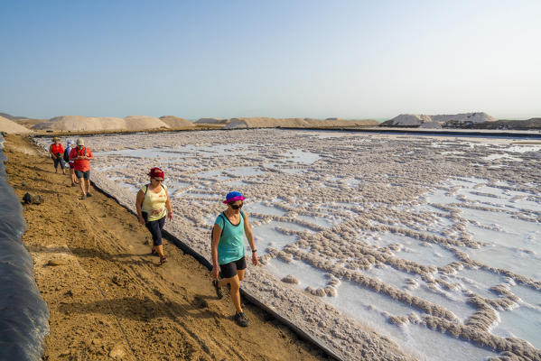Tourists walking on shores of salt flats of Lake Afrera (or Lake Afdera), Danakil Depression, Afar Region, Ethiopia, Africa