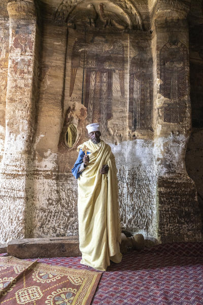 Orthodox priest holding the hand cross inside the old Maryam Korkor church, Gheralta Mountains, Tigray Region, Ethiopia