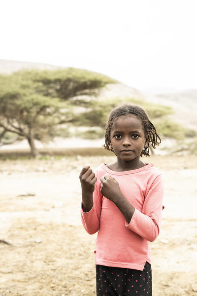 Young baby girl in the arid landscape, Melabday, Asso Bhole, Danakil Depression, Afar Region, Ethiopia, Africa