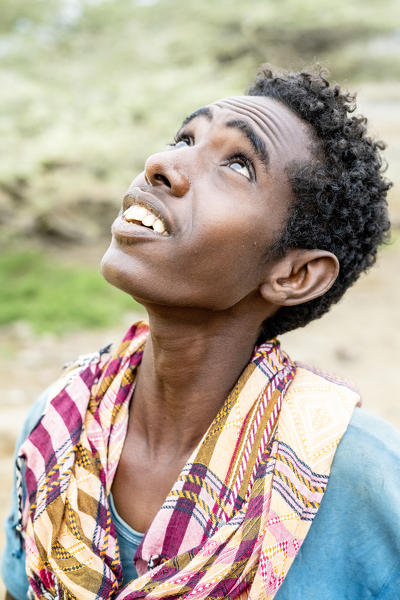 Side view of teenage boy looking up, Melabday, Asso Bhole, Danakil Depression, Afar Region, Ethiopia, Africa