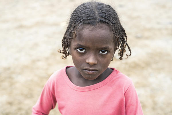 Portrait of cute little baby girl with braids, Melabday, Asso Bhole, Danakil Depression, Afar Region, Ethiopia, Africa