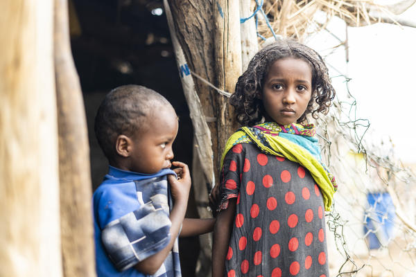 Young girl with little brother boy in Melabday village, Asso Bhole, Danakil Depression, Afar Region, Ethiopia, Africa