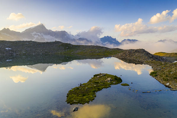 Galenstock mountain mirrored in the clear water of Obere Schwarziseeli lake at sunrise, Furka Pass, Canton Uri, Switzerland