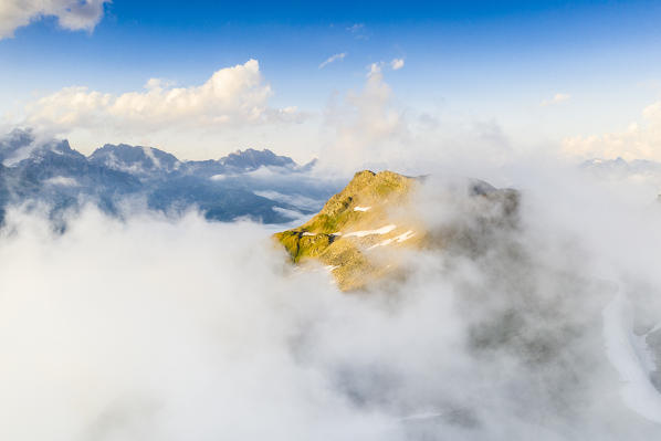 Stotzigen Firsten mountain peak emerging from fog, aerial view, Furka Pass, Canton Uri, Switzerland
