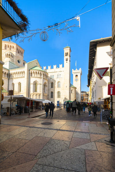 People enjoying the shopping at Christmas markets close to the Duomo or cathedral, Trento, Trentino, Italy