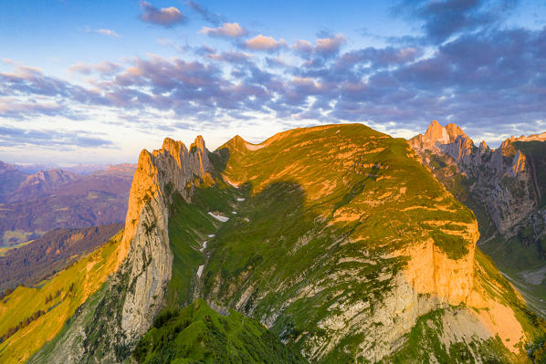 Aerial view of Santis and Saxer Lucke mountain peaks lit by sunrise, Appenzell Canton, Alpstein Range, Switzerland