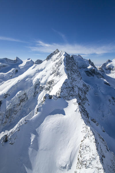 Aerial view of the long crest of ice and rock that takes to Bernina peak. Engadine. Canton of Graubunden Switzerland.