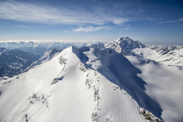 Aerial view of Piz Fora and Mount Disgrazia in winter. Engadine, Canton Grigioni, Switzerland.