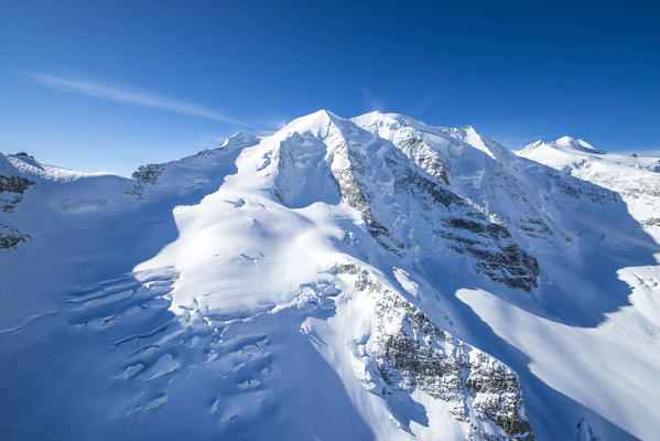 Aerial view of Piz Palù with the crevasses of its glacier, Val Roseg, Engadine, Canton Grigioni, Switzerland.