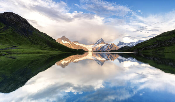 Peaks mirrored in the pristine water of Bachalpsee lake at sunset, Grindelwald, Bernese Oberland, Bern Canton, Switzerland