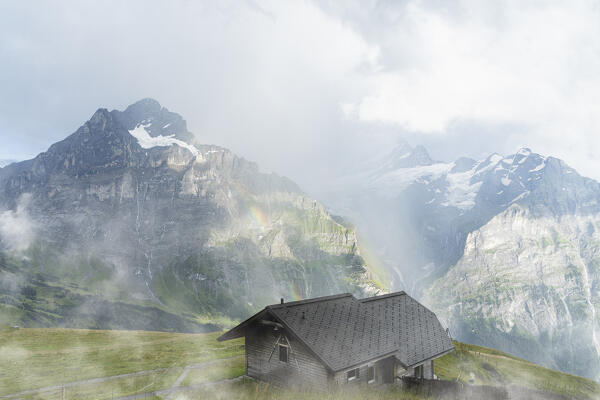 Rainbow over Wetterhorn and Schreckhorn mountains view from wood hut, Grindelwald, Bernese Alps, Canton of Bern, Switzerland