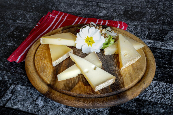 Selection of typical italian cheese in wood chopping board