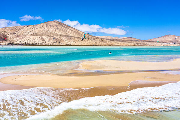 Kitesurf flying on ocean waves at Sotavento beach (Playa de Sotavento de Jandia), Fuerteventura, Canary Islands, Spain