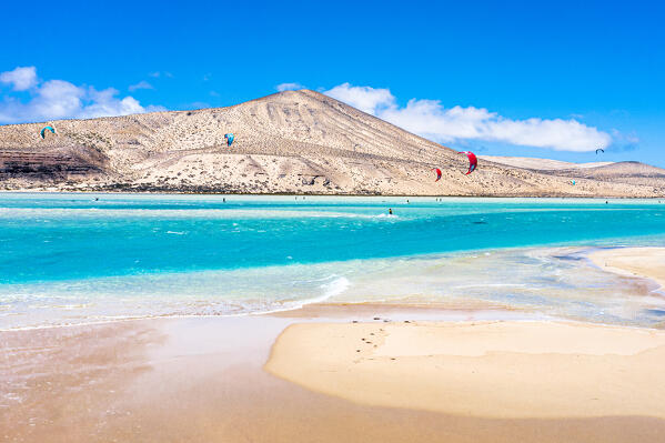Kitesurf flying on ocean waves at Sotavento beach (Playa de Sotavento de Jandia), Fuerteventura, Canary Islands, Spain